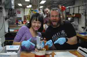 Graduate School of Oceanography) take microbiology samples. Ann Dunlea (Boston University) photobombs in the background. 